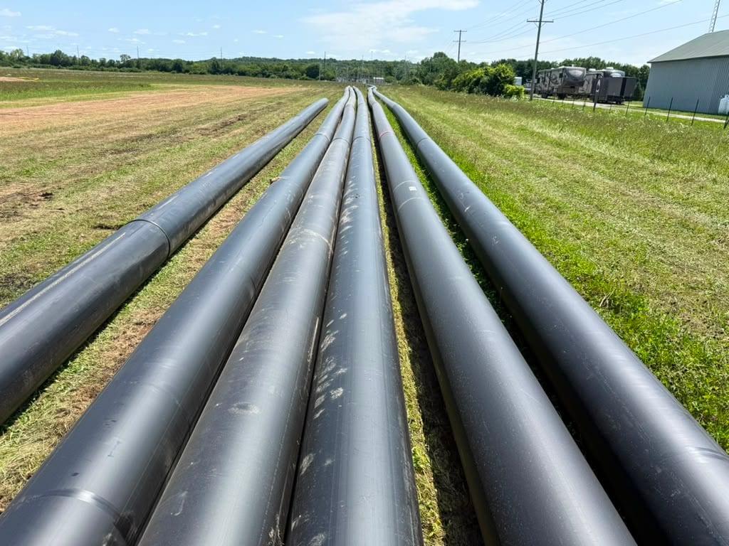 Fused HDPE pipe strings staged along a pipeline right-of-way